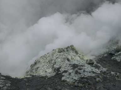 Stinking sulphur steams ascending from the bottom of the crater